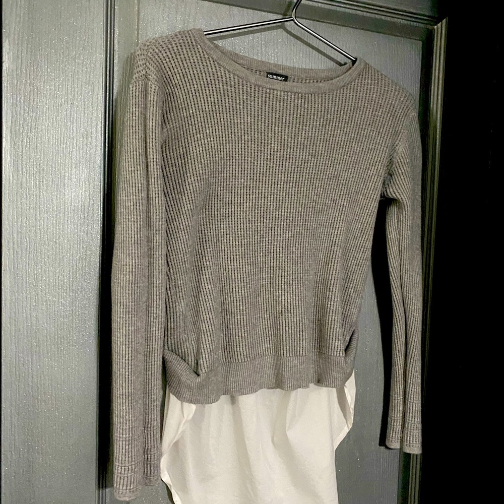 Gray sweater over white shirt bottom